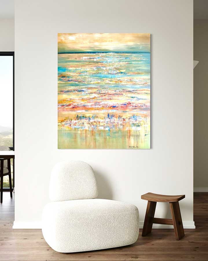 Abstract painting on a wall above a white armchair and wooden stool.