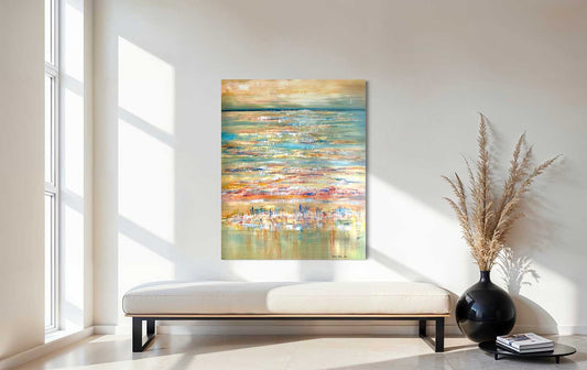 Abstract painting on a wall in a modern living room with a vase and books on a table.